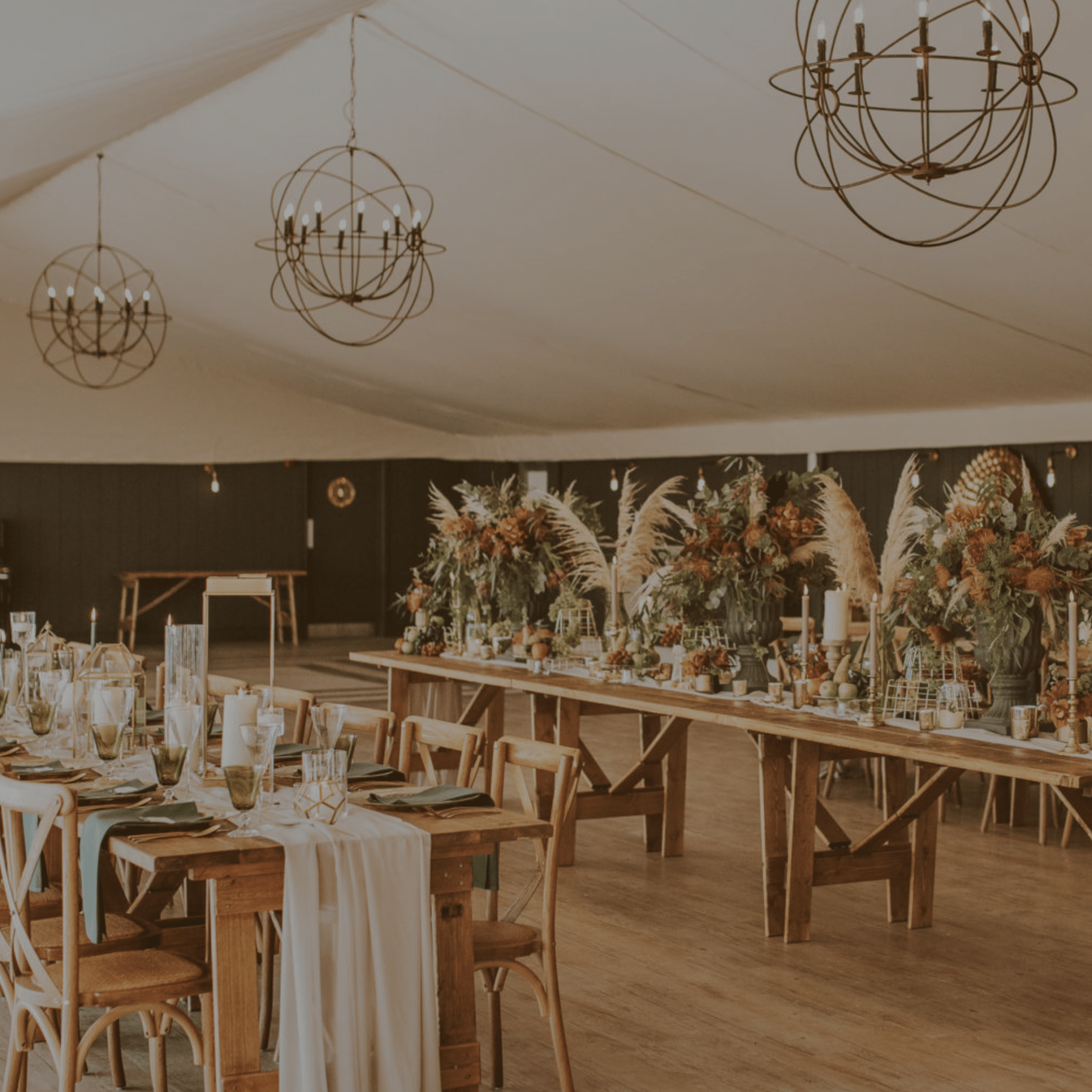 Wedding reception in a tent with long tables