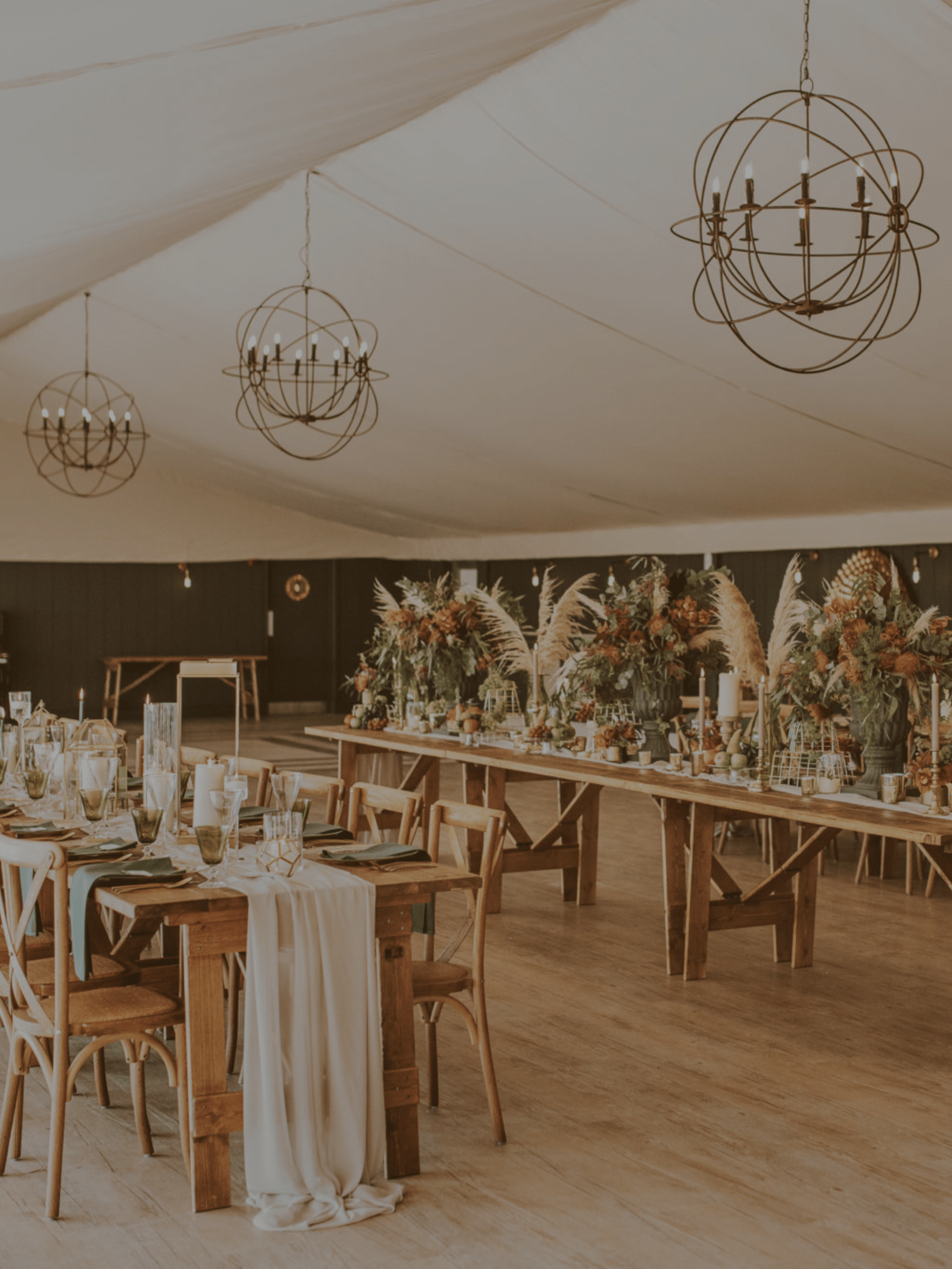 wedding reception organised in Cambridge in.a tent with long tables